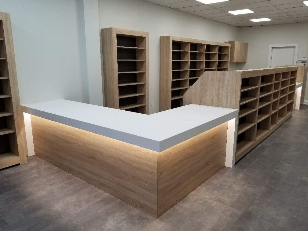 Wood-finish reception counter and open storage shelves