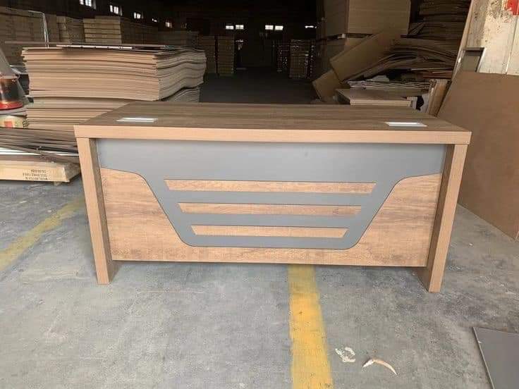 Custom wood-finish counter with contrasting grey panel in the workshop